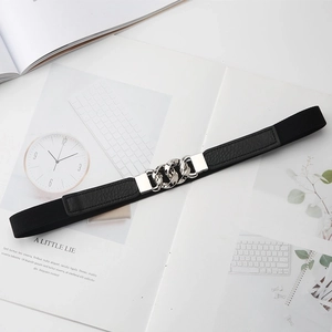 Detail of black elastic waist belt with a stylish silver metal chain buckle on a magazine