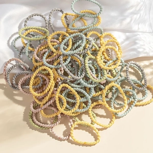 Bulk set of colorful spiral hair ties in yellow, grey, and pink for kids hair styling