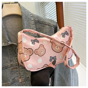 Close-up of pink fabric tote bag featuring cute cartoon bear and bow patterns