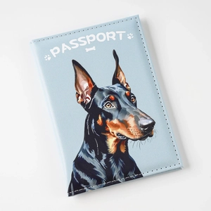 Detailed view of light blue PU leather passport holder with Doberman print and white text