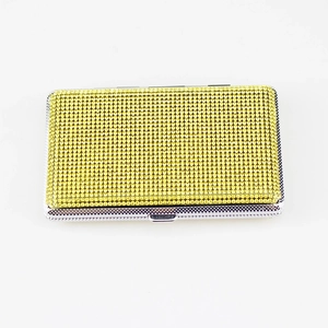 Detail of a rectangular cigarette case fully set with sparkling yellow rhinestones