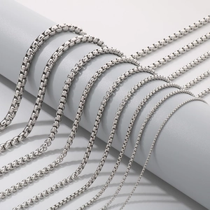 Classic silver stainless steel pearl link chains in multiple sizes displayed on a stand