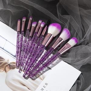 Detail of 10-piece makeup brush set with purple glitter handles and gradient soft bristles