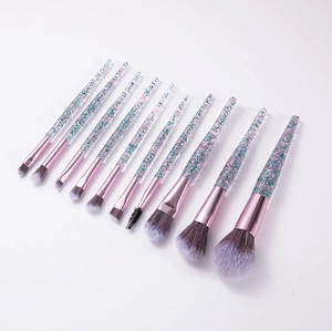 Detail of 10 makeup brushes with pink glitter sand handles and pink metal ferules
