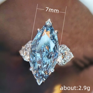 Marquise cut light blue zircon wedding ring with side diamonds in silver finish
