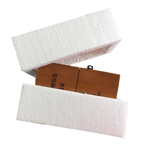 Useless Box novelty wooden toy in brown wood grain placed in white foam packaging