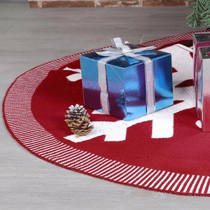 Detail of red knit Christmas tree skirt featuring white snowflakes and striped borders