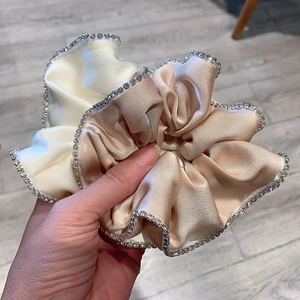 Set of two satin scrunchies in cream and champagne gold with sparkling rhinestone edges