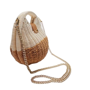 Shell-shaped woven straw handbag with brown leather handle and gold chain strap