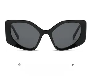 Close-up of chunky black cat-eye sunglasses with thick frames and dark polarized lenses