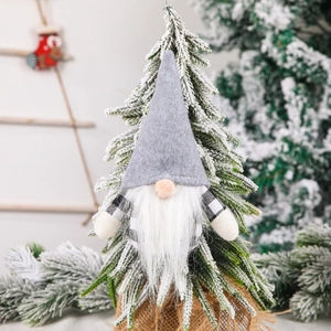 Nordic Christmas gnome hanging ornament in grey felt and long fur on a snowy pine tree