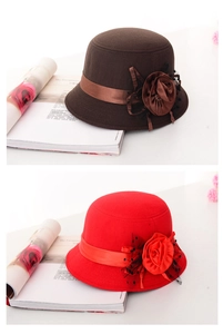 Close-up of elegant wool felt cloche hats in brown and red with mesh and floral detail
