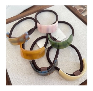 Detailed view of six vintage acetate ponytail holders with France Handmade lettering