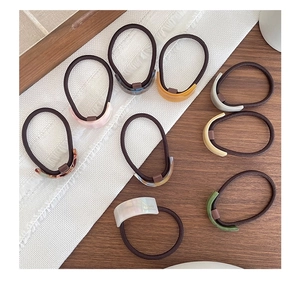 Flat lay of acetate hair ties in various Morandi colors with resin rectangle accents