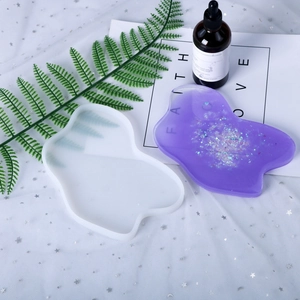 Detailed view of translucent silicone mold with purple glitter resin coaster sample