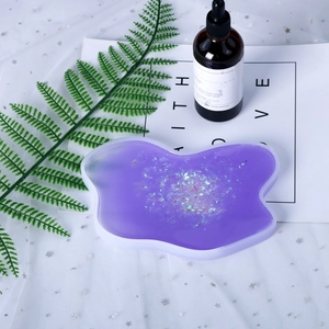 Macro shot of irregular wave silicone coaster mold filled with purple glitter resin