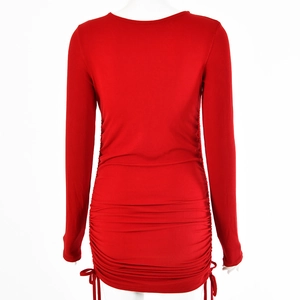 Rear view of red long sleeve dress featuring ruched details and side drawstrings