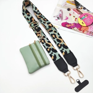 Detail of adjustable leopard print wide strap and mint green dual zipper crossbody pouch