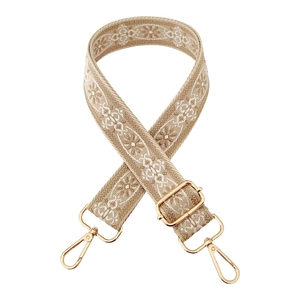 Close-up of khaki jacquard strap with white embroidery and golden metal buckles