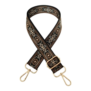 Close-up of ethnic embroidery on adjustable wide bag strap with gold lobster clasps