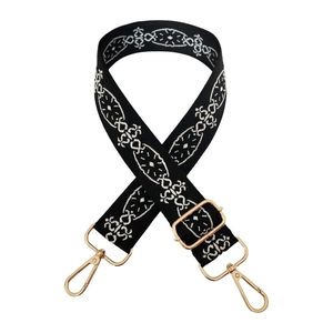 Close-up of 3.8cm wide ethnic jacquard strap with gold metal hooks and geometric embroidery