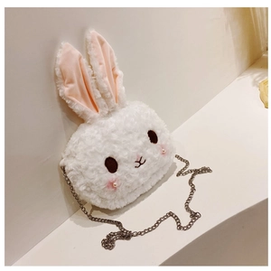 Detailed close-up of white plush bunny crossbody bag with pearl metal chain strap