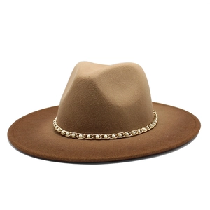 Detail of two-tone wool fedora featuring a gold chain and faux pearl decorative band