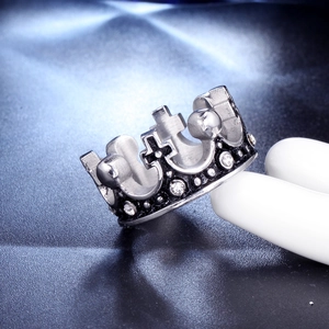 Close-up of a silver crown ring with cross details and inlaid sparkling cubic zirconia