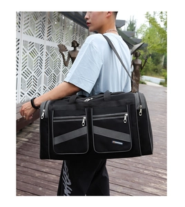 Outdoor shot of a black Oxford travel bag with adjustable strap and large capacity