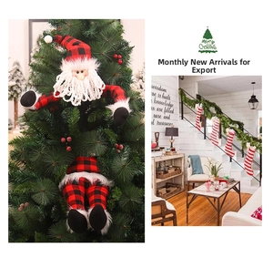 Close-up of Santa Claus tree topper in red and black plaid fabric for Christmas decor