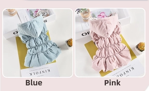 Detailed close-up of blue and pink quilted dog puffer vests with floral hood lining