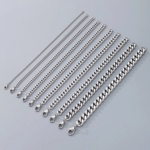 Multiple sizes of silver Cuban link bracelets with lobster clasps shown on grey background