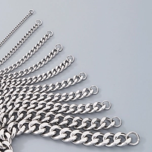 Macro shot showing multiple widths of polished stainless steel Cuban link chains