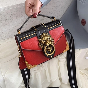 Retro red and black leather crossbody bag with metal rivets and lion head buckle decoration