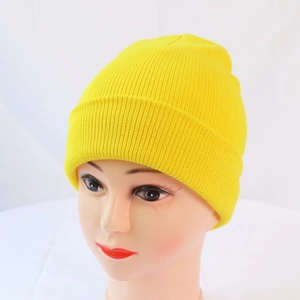 Detail of bright yellow knit beanie showing the ribbed texture and wide cuffed brim design