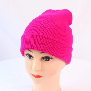 Detailed knit texture of a vibrant rose red elastic beanie on a display head model