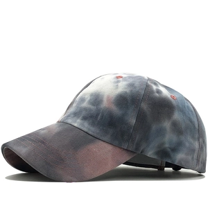 Detail of colorful tie-dye cotton baseball cap with curved brim and red eyelets