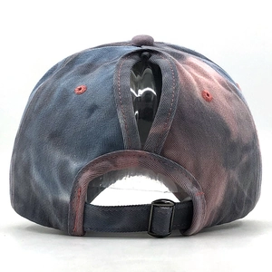 Detail of colorful tie-dye baseball cap featuring ponytail hole and metal buckle