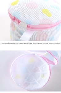 Detail view of cylindrical mesh laundry bag with pink zipper and colorful heart patterns