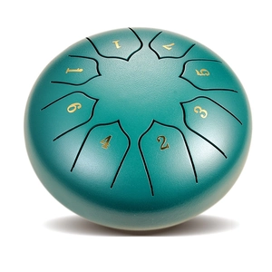 Detailed top view of a green 8-note steel tongue drum with golden numbered scales
