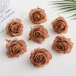 Close-up of vintage dusty pink artificial silk rose heads for wedding floral arrangements