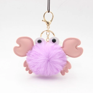 Detail of purple fluffy crab keychain with pink PU leather claws and gold metal clip