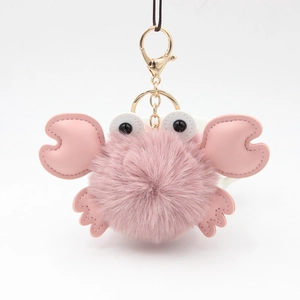 Close-up of a pink plush crab keychain with PU leather claws and a golden lobster clasp
