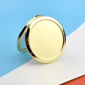 Detail of rose gold round metal pocket mirror with foldable structure on colorful background