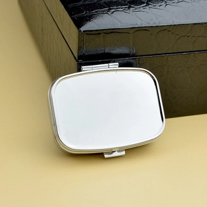Sleek rectangular silver metal pill box with a polished finish for daily portable storage