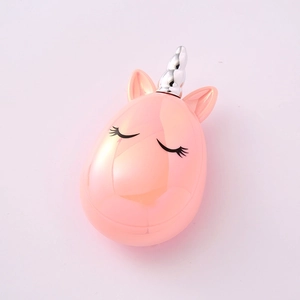Detailed view of a pink unicorn-shaped container with a silver horn and eyelash design