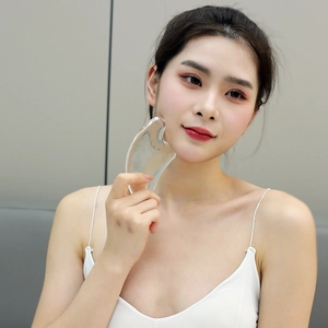 3D transparent crystal facial gua sha tool for face lifting and massage on model