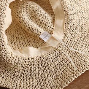Detailed macro view of the inner sweatband and adjustable drawstring of a paper straw hat
