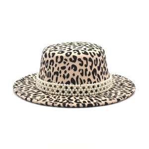 Detail of leopard print flat top fedora hat featuring three-layer pearl decorative band