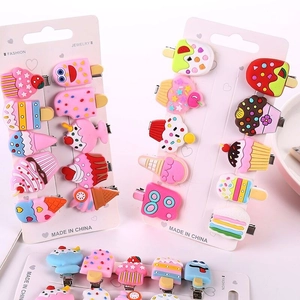 Close-up of colorful resin hair clip set featuring cute cartoon dessert shapes on a white card